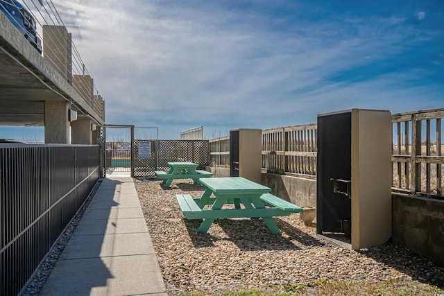 view of home's community featuring a gate and fence