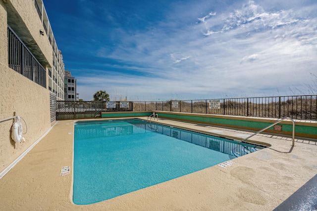 community pool featuring fence