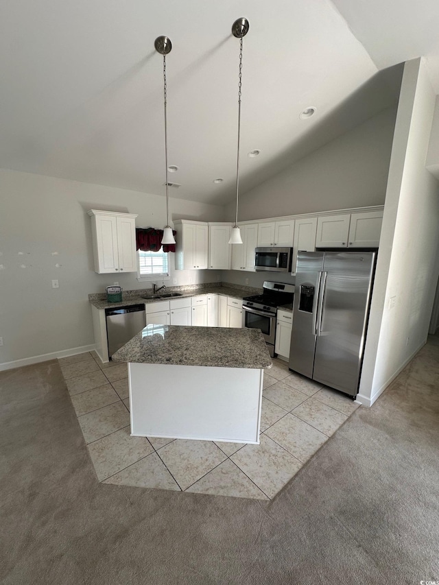 kitchen with appliances with stainless steel finishes, light carpet, white cabinetry, and light tile patterned flooring