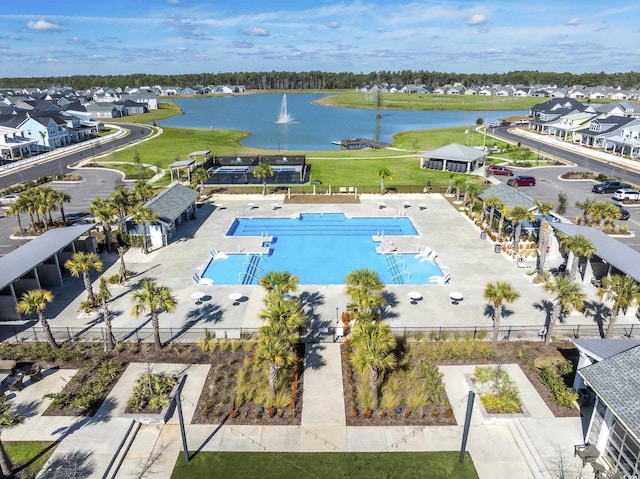 drone / aerial view featuring a residential view and a water view