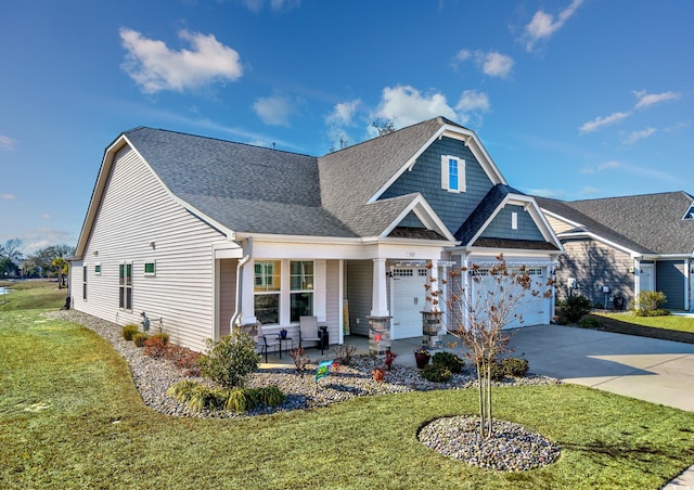 craftsman house with a porch, a front yard, roof with shingles, and driveway