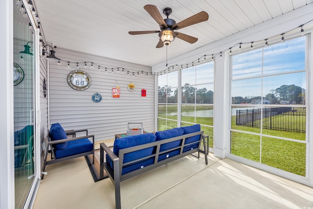 sunroom featuring a ceiling fan