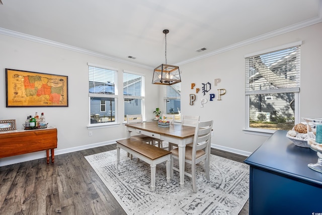 dining room featuring ornamental molding, dark wood-style flooring, visible vents, and baseboards