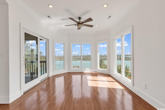 unfurnished sunroom with a ceiling fan and visible vents