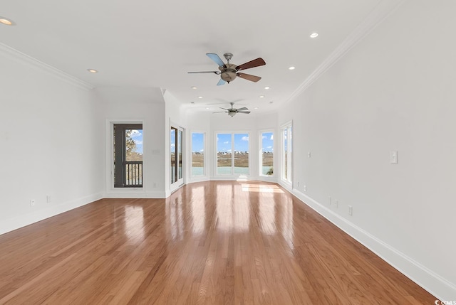 unfurnished living room with baseboards, crown molding, recessed lighting, and light wood-style floors