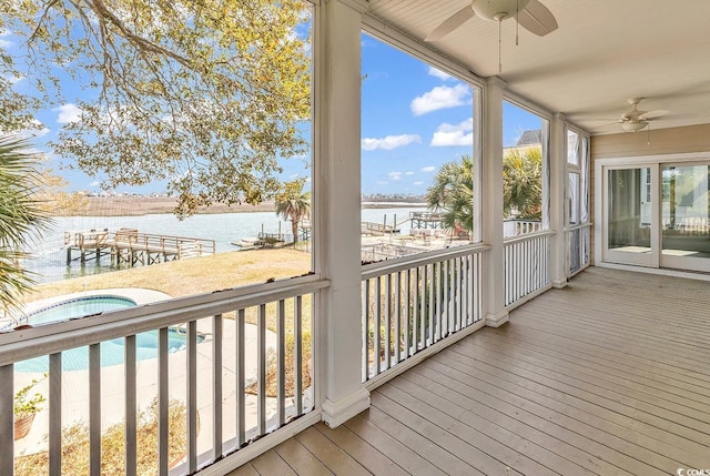 deck with a water view, a jacuzzi, and ceiling fan