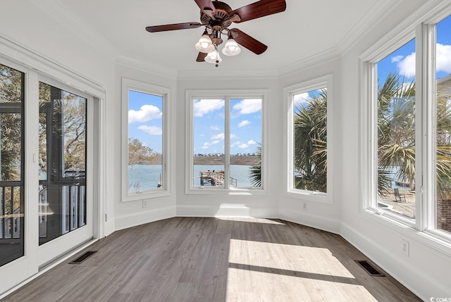 unfurnished sunroom with a water view, visible vents, and a ceiling fan