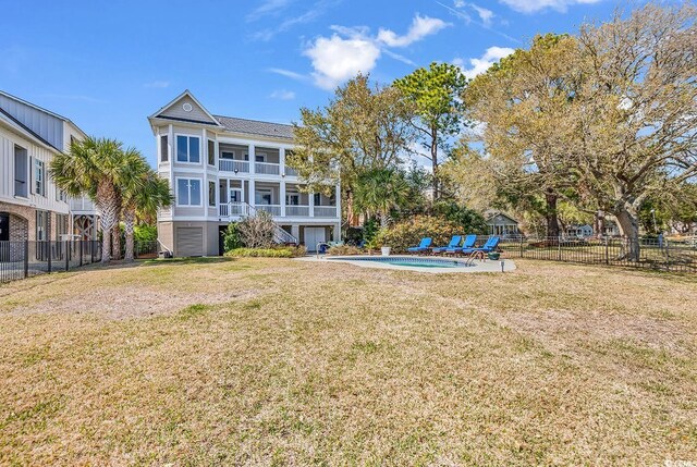 exterior space with a fenced in pool, fence, a balcony, and stairs