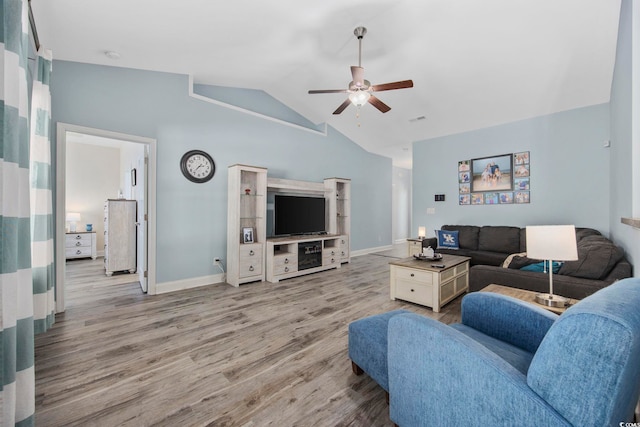 living area featuring vaulted ceiling, baseboards, a ceiling fan, and light wood-style floors