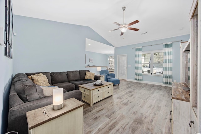 living area with baseboards, visible vents, a ceiling fan, vaulted ceiling, and light wood-style floors