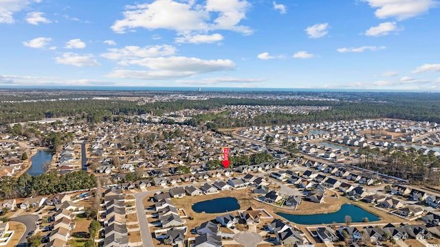 drone / aerial view featuring a water view and a residential view