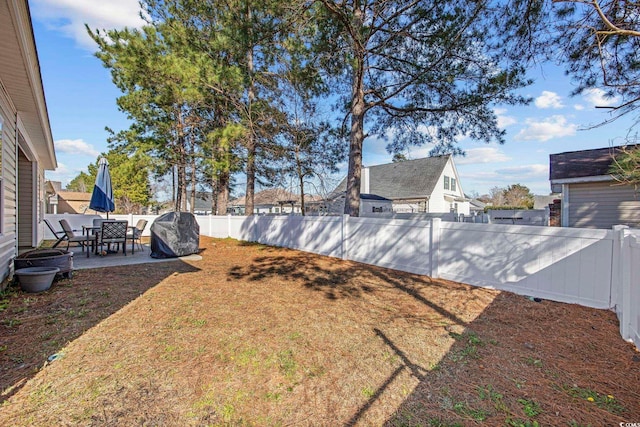 view of yard featuring a patio area and a fenced backyard