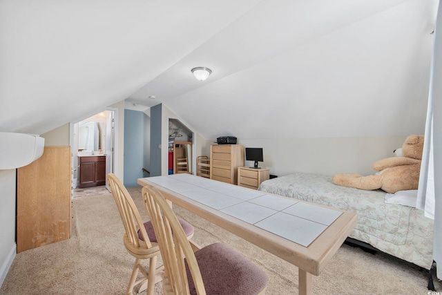 bedroom featuring vaulted ceiling and light colored carpet