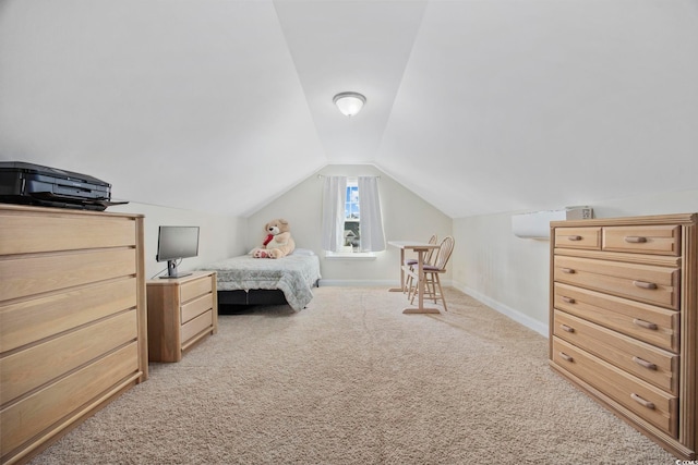 bedroom featuring lofted ceiling, light colored carpet, and baseboards