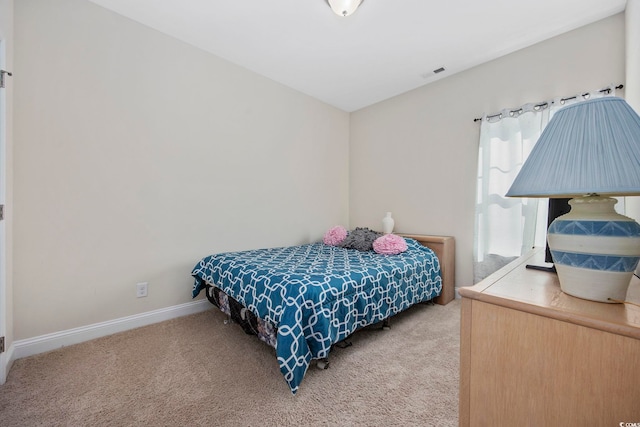 carpeted bedroom with visible vents and baseboards