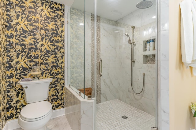 full bath with toilet, a stall shower, and baseboards