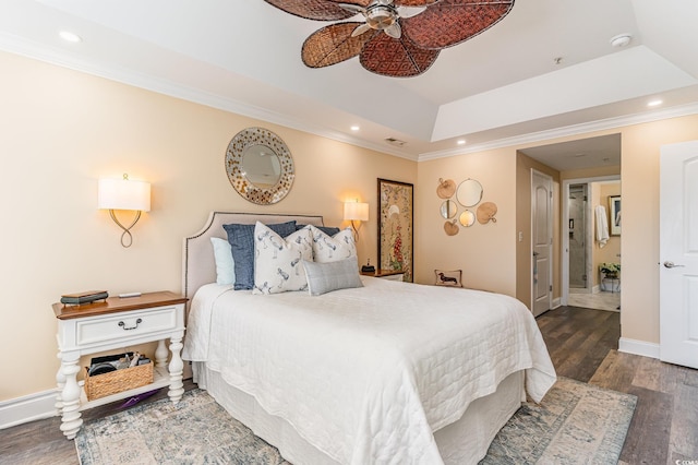 bedroom featuring a tray ceiling, recessed lighting, ornamental molding, wood finished floors, and baseboards