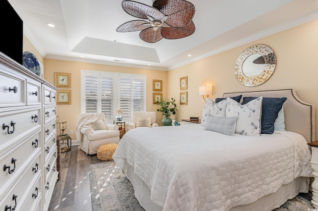 bedroom with a raised ceiling, ceiling fan, ornamental molding, wood finished floors, and recessed lighting