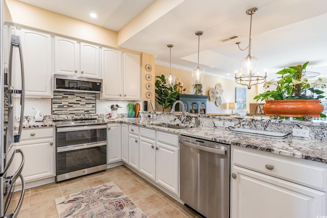 kitchen featuring tasteful backsplash, visible vents, stainless steel appliances, white cabinetry, and a sink