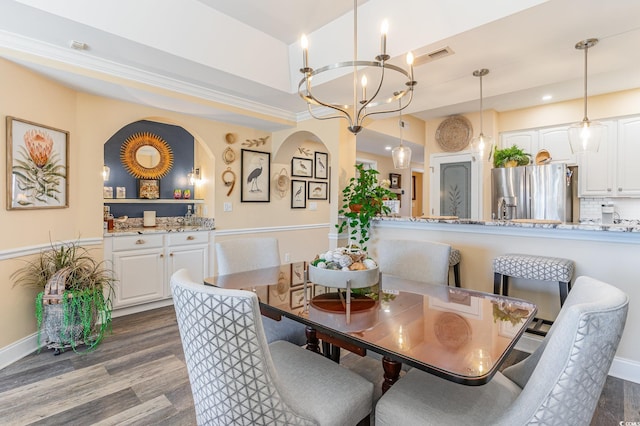 dining space with a chandelier, dark wood-style flooring, and visible vents