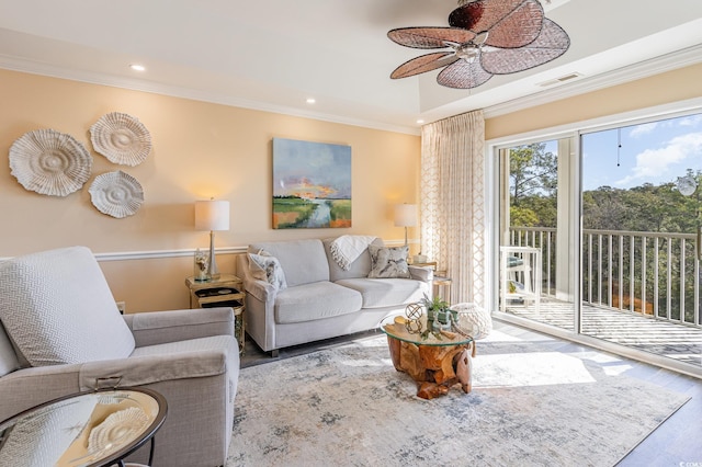 living area featuring ornamental molding, recessed lighting, visible vents, and wood finished floors