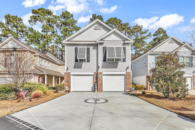 traditional-style home featuring driveway, a garage, and brick siding