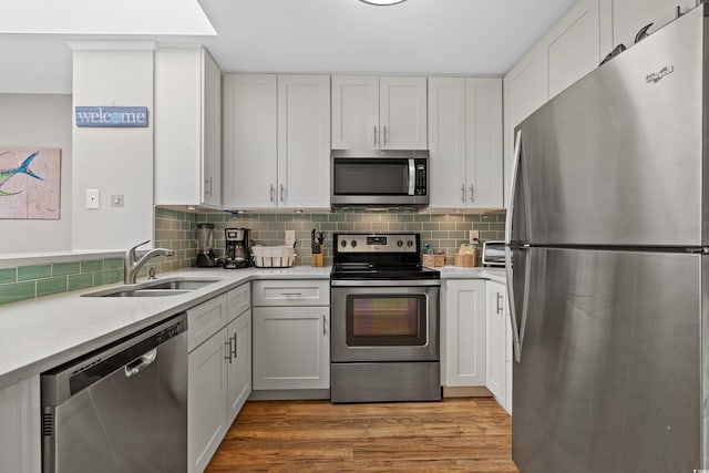 207 3rd Ave N Unit 348, North Myrtle Beach, SC 29582 - kitchen featuring stainless steel appliances, a sink, light countertops, and tasteful backsplash