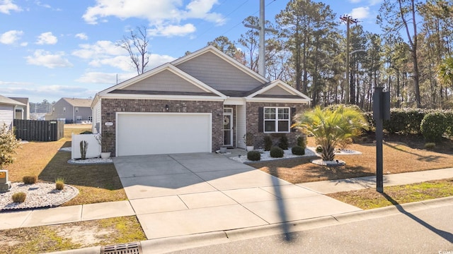 craftsman-style house featuring an attached garage, fence, concrete driveway, and brick siding