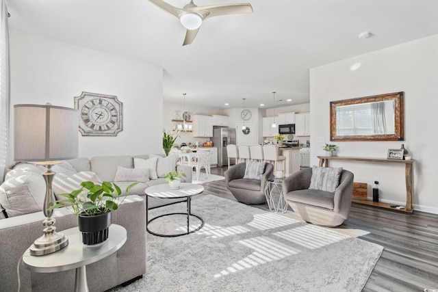 living room with a ceiling fan, recessed lighting, baseboards, and wood finished floors