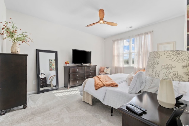 carpeted bedroom with visible vents and a ceiling fan