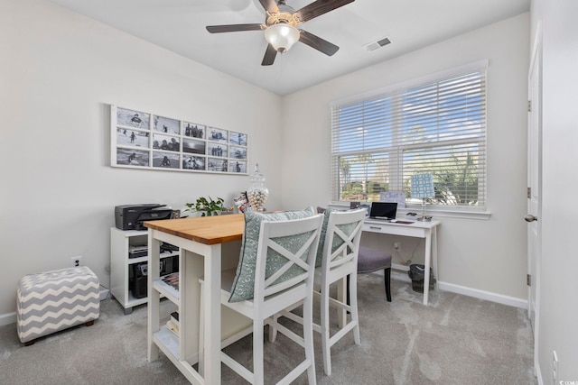 carpeted home office with baseboards, visible vents, and ceiling fan