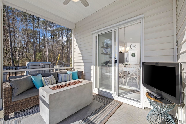 view of patio / terrace with an outdoor fire pit and a ceiling fan