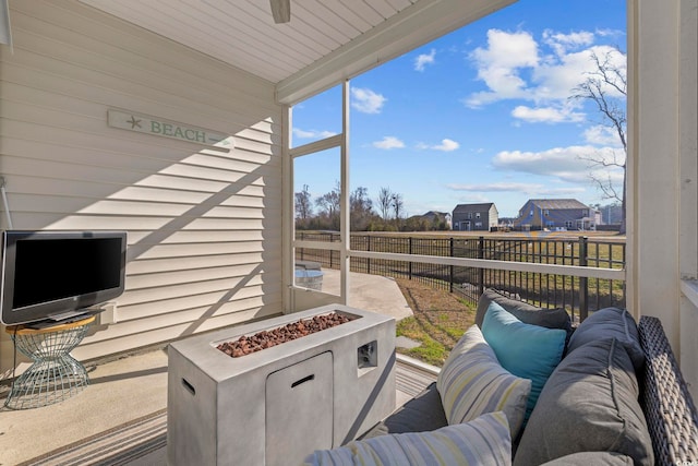 wooden terrace with an outdoor fire pit and a fenced backyard