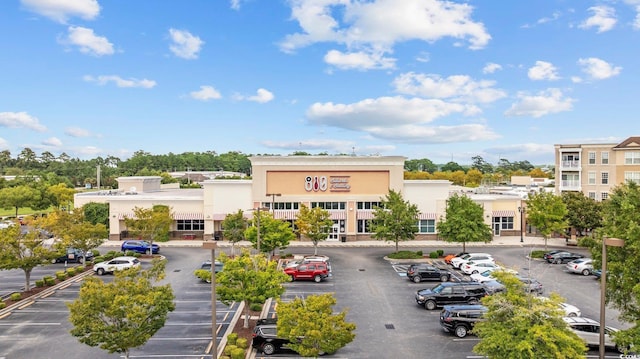 view of building exterior featuring uncovered parking