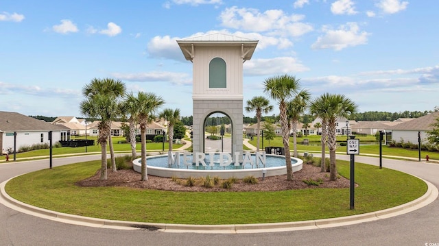 view of property's community with a residential view and a lawn