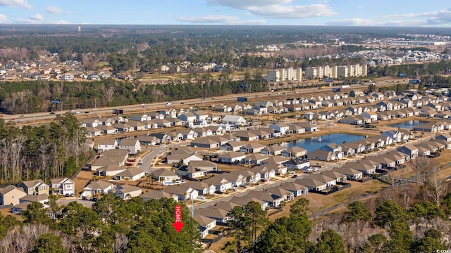 birds eye view of property with a water view and a residential view