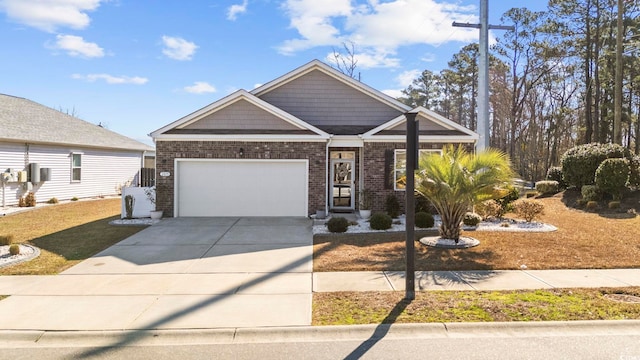 craftsman inspired home with a garage, concrete driveway, and brick siding