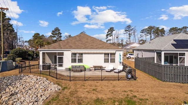 back of house featuring a yard, fence private yard, a sunroom, and a patio