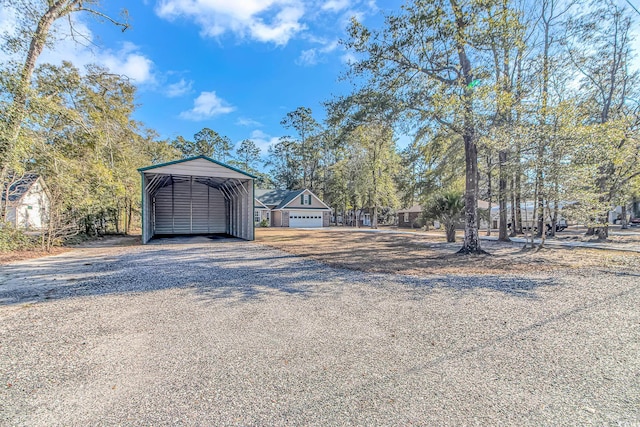 exterior space with gravel driveway and a detached carport