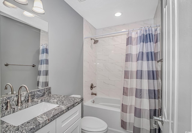 bathroom featuring toilet, shower / bath combo, and vanity