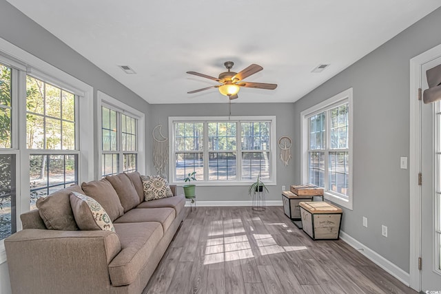 sunroom / solarium featuring plenty of natural light, visible vents, and a ceiling fan