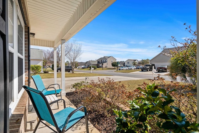 exterior space featuring covered porch and a residential view