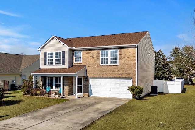 traditional home with brick siding, fence, driveway, and a front lawn