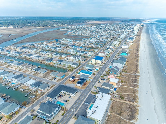 bird's eye view featuring a water view and a view of the beach