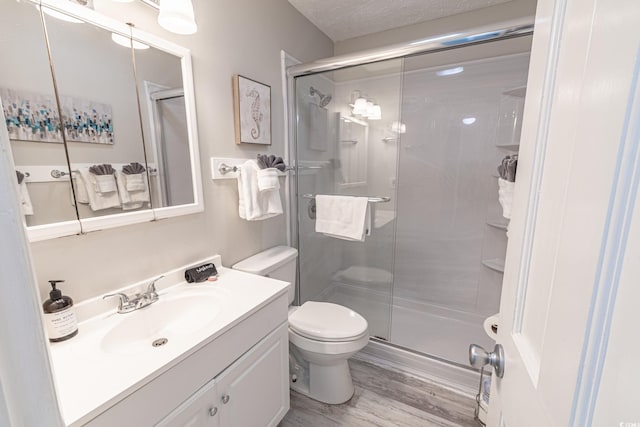 full bathroom with a shower stall, toilet, and a textured ceiling