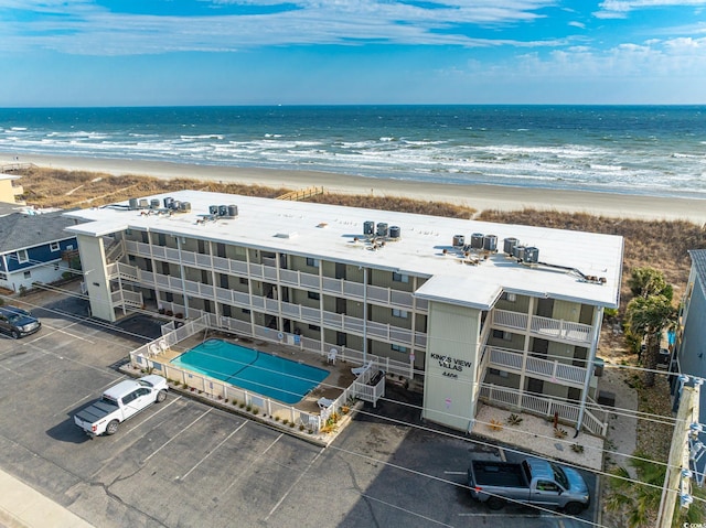 drone / aerial view featuring a water view and a view of the beach