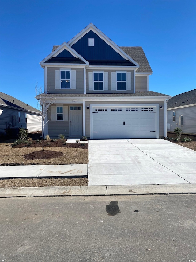 view of front facade featuring concrete driveway and an attached garage