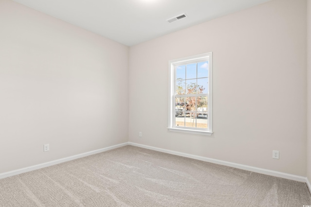 unfurnished room with carpet floors, baseboards, and visible vents