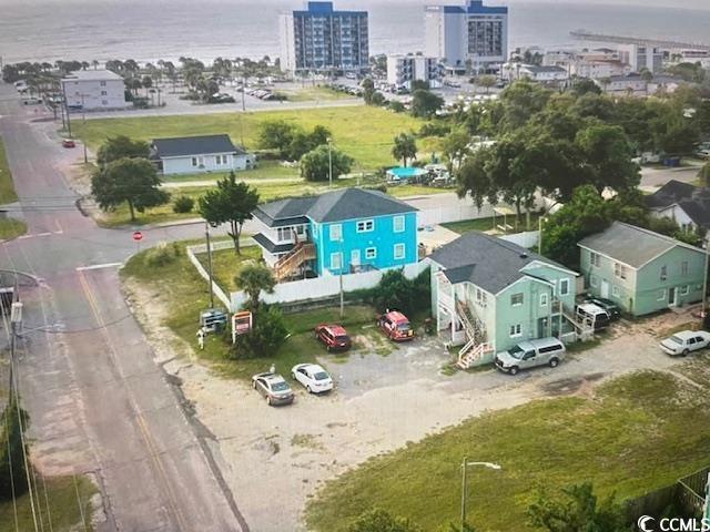 birds eye view of property with a water view and a city view