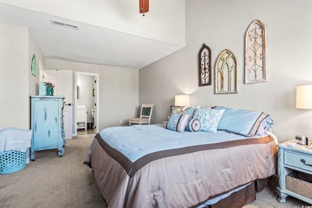 carpeted bedroom with visible vents, ceiling fan, and ensuite bathroom